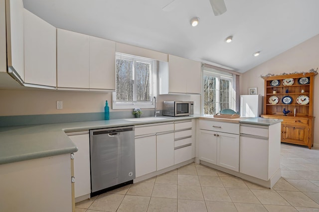 kitchen with light tile patterned floors, white cabinetry, stainless steel appliances, and a sink