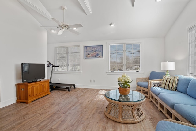 living room with baseboards, light wood finished floors, a ceiling fan, and vaulted ceiling