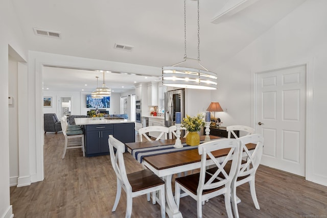 dining space featuring visible vents, recessed lighting, and wood finished floors