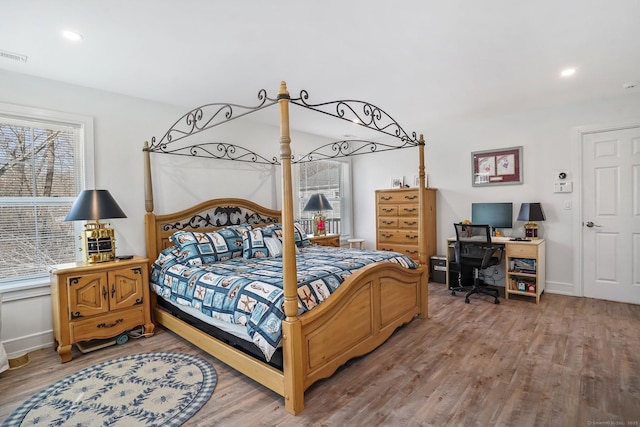 bedroom featuring recessed lighting, visible vents, baseboards, and wood finished floors