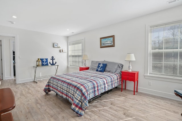 bedroom with recessed lighting, baseboards, and wood finished floors