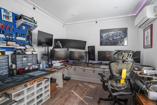 home office featuring crown molding, wood finished floors, baseboards, and a wall mounted AC