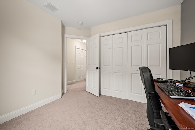 office featuring baseboards, light carpet, and visible vents