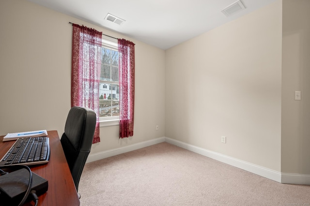 office space with carpet flooring, baseboards, and visible vents