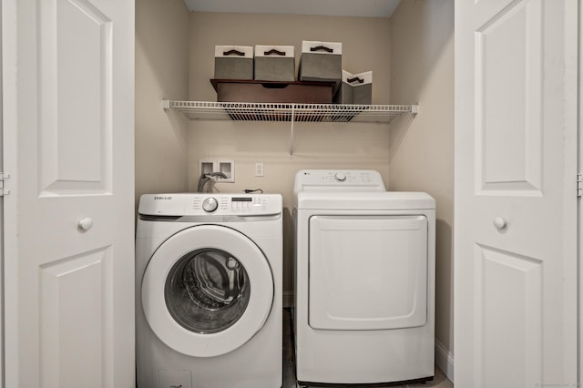 washroom with washer and clothes dryer and laundry area