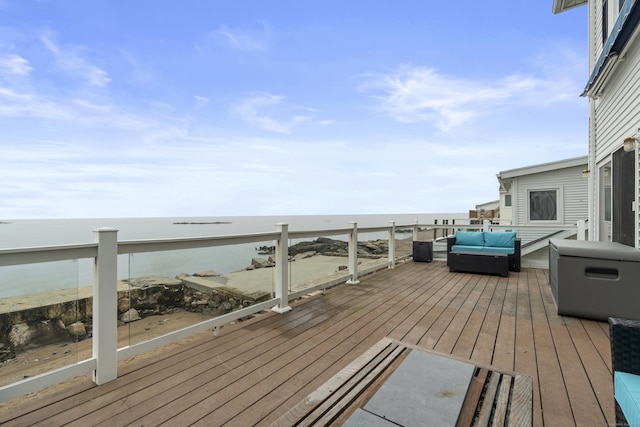 wooden deck with an outdoor living space and a water view