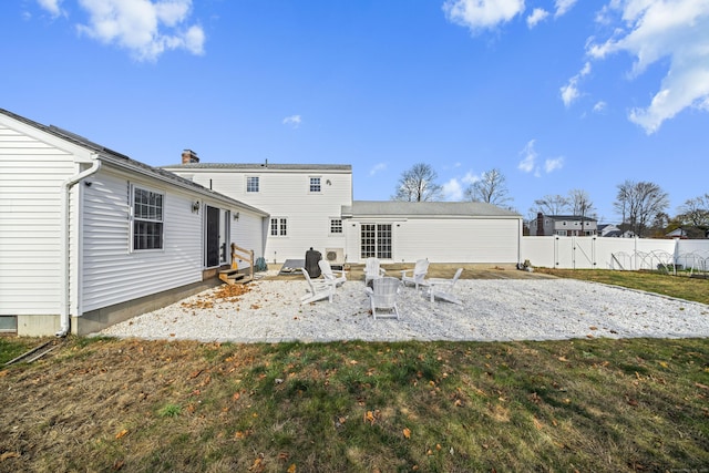 rear view of property featuring fence, a chimney, entry steps, a patio area, and a lawn