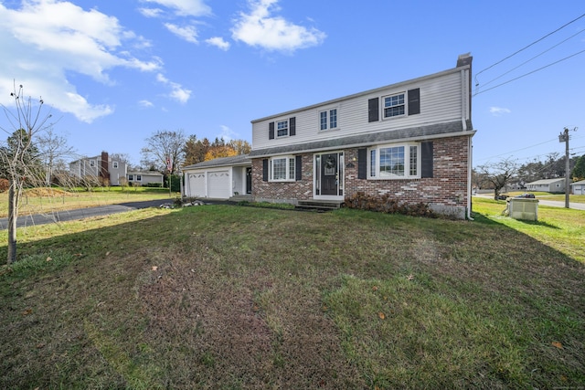 view of front facade with driveway, an attached garage, a front yard, brick siding, and a chimney