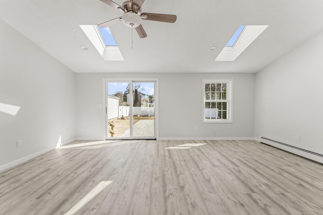 unfurnished living room with light wood-type flooring, baseboards, and vaulted ceiling