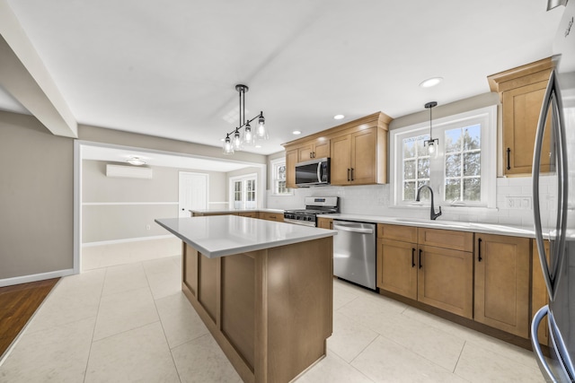 kitchen featuring a sink, plenty of natural light, tasteful backsplash, stainless steel appliances, and light tile patterned floors