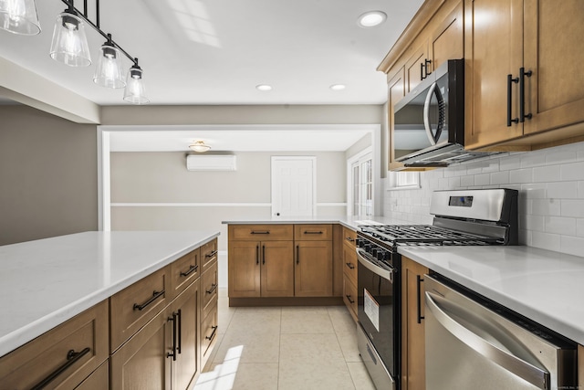 kitchen with light countertops, light tile patterned floors, brown cabinetry, stainless steel appliances, and a wall mounted AC