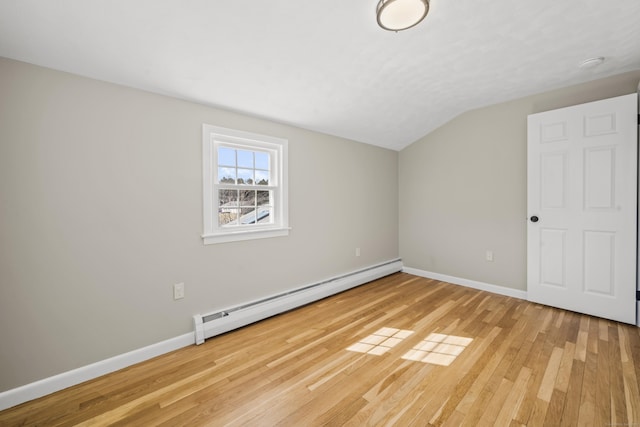 unfurnished room featuring lofted ceiling, light wood-type flooring, baseboards, and a baseboard radiator