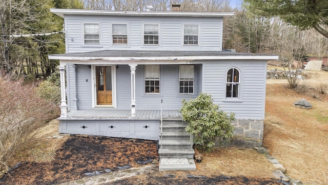 view of front of property with a porch and a chimney