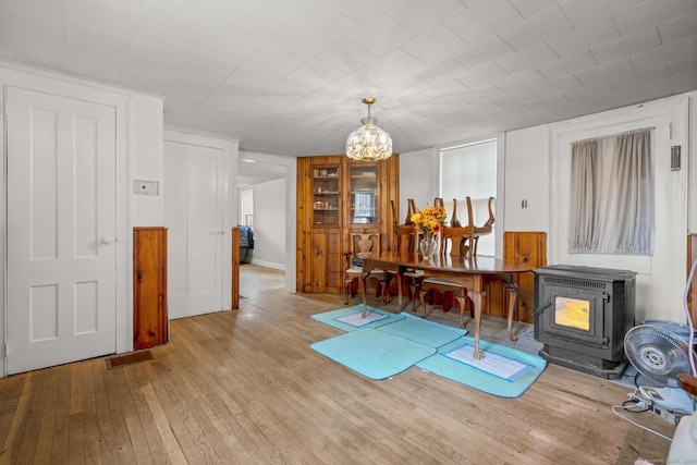 exercise room featuring a chandelier and hardwood / wood-style flooring