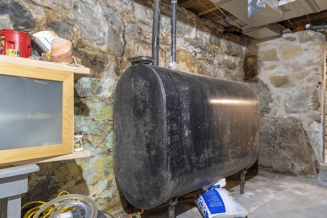 interior space with unfinished concrete flooring and heating fuel