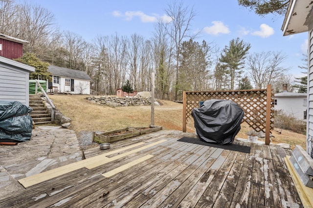 deck featuring grilling area and an outbuilding