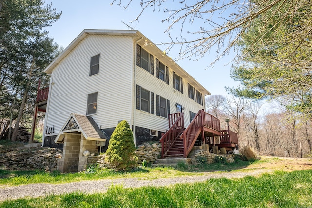 exterior space featuring a wooden deck and stairs