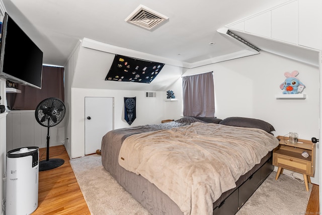 bedroom with light wood-type flooring and visible vents