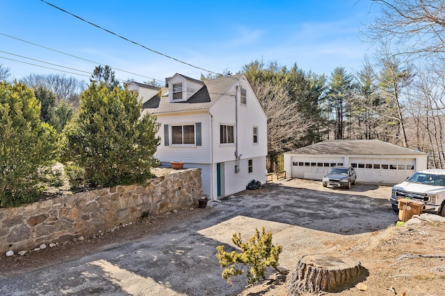 view of home's exterior featuring a detached garage and an outdoor structure