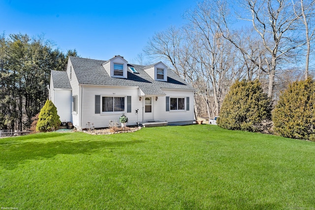 rear view of house with a lawn and a shingled roof