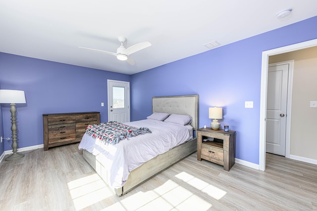 bedroom featuring visible vents, light wood-style floors, baseboards, and ceiling fan