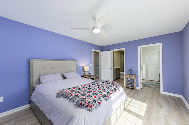 bedroom featuring connected bathroom, light wood-type flooring, baseboards, and ceiling fan