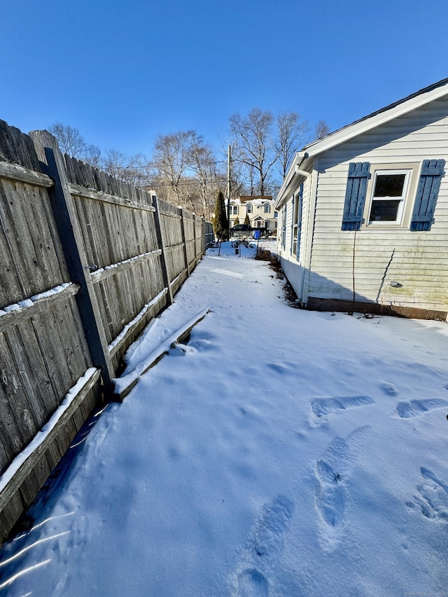 yard layered in snow with fence