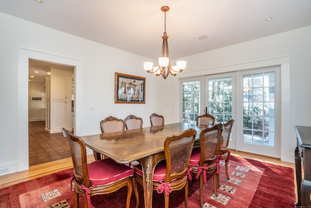 dining space featuring an inviting chandelier and wood finished floors