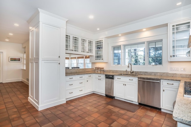 kitchen with stainless steel dishwasher, recessed lighting, white cabinetry, and a sink