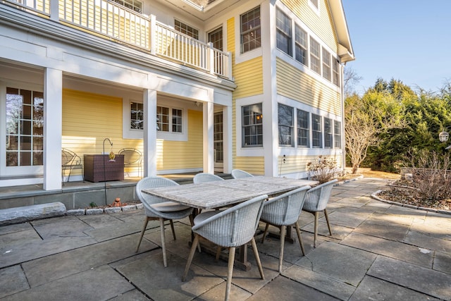 view of patio / terrace featuring outdoor dining space and a balcony