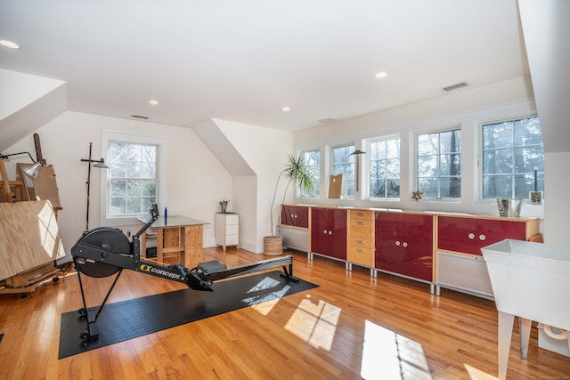 workout area featuring recessed lighting, wood finished floors, and visible vents