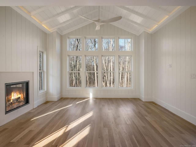 412 Tanner Marsh Rd, Guilford, CT 06437 - unfurnished living room featuring a ceiling fan, a glass covered fireplace, wood finished floors, baseboards, and wooden walls