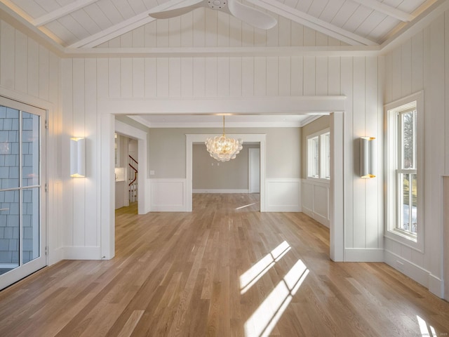 412 Tanner Marsh Rd, Guilford, CT 06437 - unfurnished dining area with a chandelier, a decorative wall, light wood finished floors, stairs, and wood ceiling