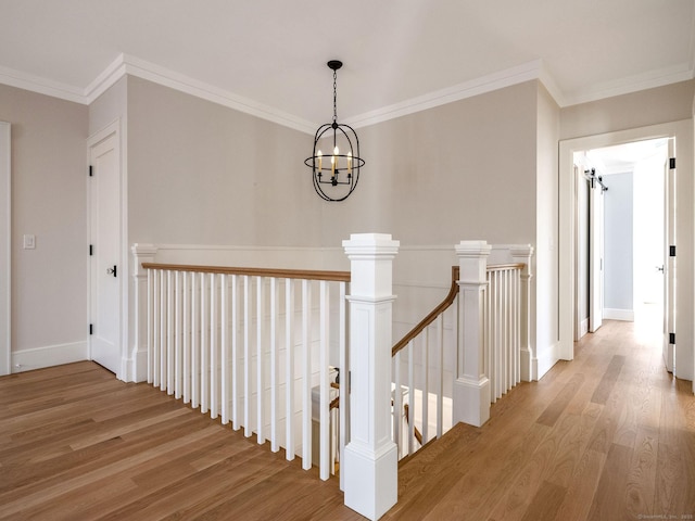 412 Tanner Marsh Rd, Guilford, CT 06437 - hallway featuring an upstairs landing, wood finished floors, a chandelier, ornamental molding, and baseboards