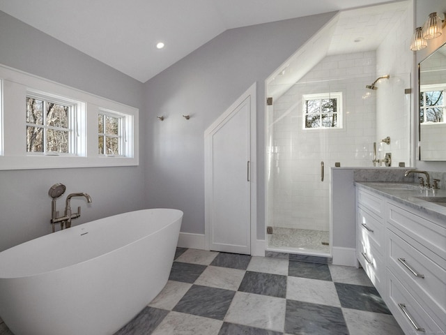 412 Tanner Marsh Rd, Guilford, CT 06437 - full bathroom with a shower stall, lofted ceiling, vanity, a soaking tub, and baseboards