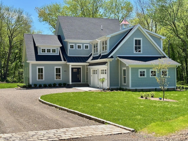 412 Tanner Marsh Rd, Guilford, CT 06437 - shingle-style home with driveway, a front lawn, and roof with shingles