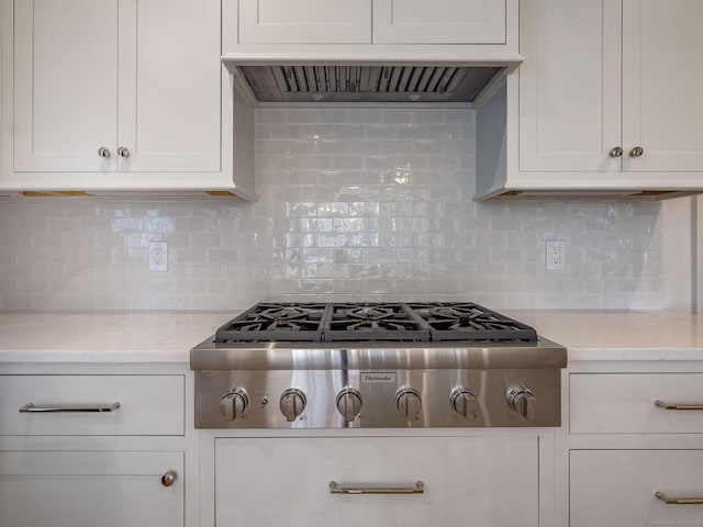 412 Tanner Marsh Rd, Guilford, CT 06437 - kitchen with stainless steel gas stovetop, range hood, white cabinets, and tasteful backsplash