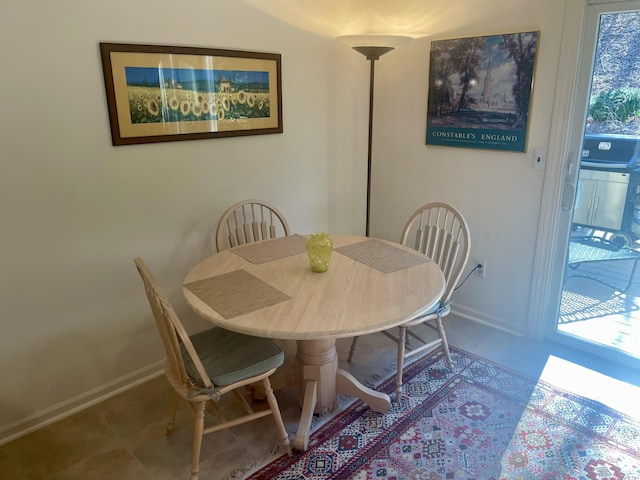 dining space with tile patterned flooring and baseboards