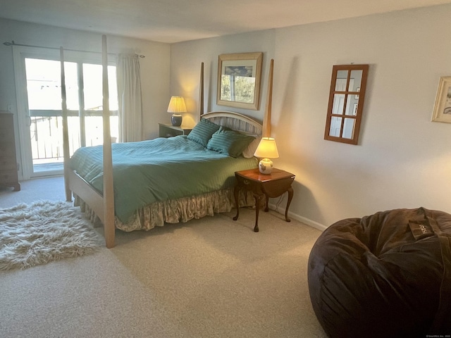 bedroom with baseboards, carpet, and access to outside