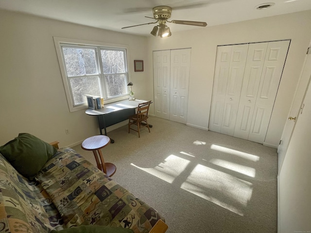 office featuring visible vents, baseboards, ceiling fan, and carpet flooring