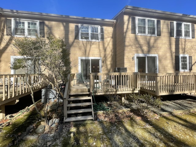 rear view of house featuring a wooden deck