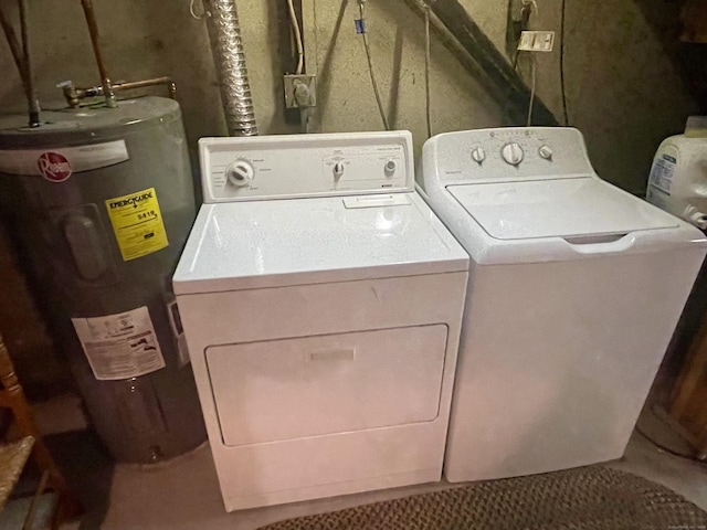 washroom with laundry area, washing machine and dryer, and electric water heater