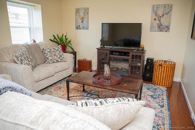 living room with wood finished floors and baseboards