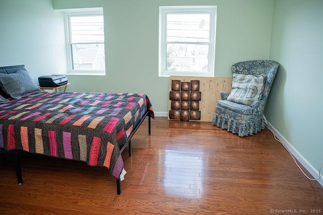 bedroom featuring baseboards and wood finished floors