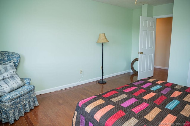 bedroom with baseboards and wood finished floors