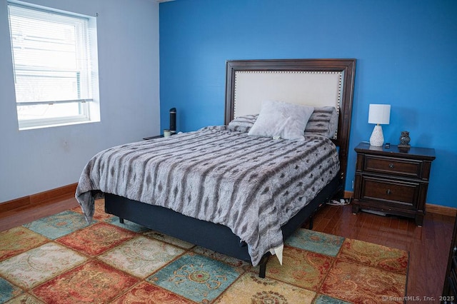 bedroom featuring wood finished floors and baseboards