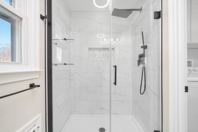 bathroom featuring a marble finish shower