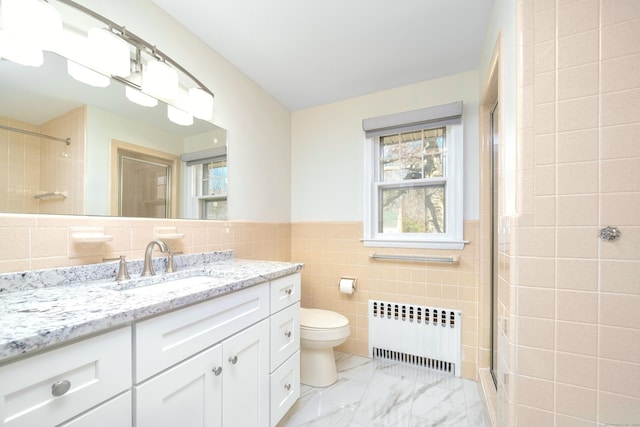 full bathroom with walk in shower, toilet, radiator heating unit, marble finish floor, and tile walls