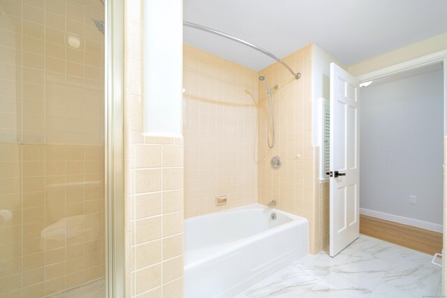 bathroom featuring baseboards and shower / bathtub combination