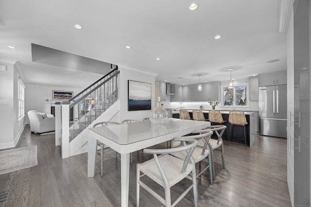 dining room with baseboards, stairway, ornamental molding, recessed lighting, and wood finished floors